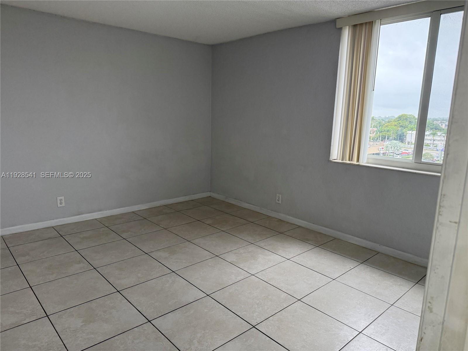 9001 Southwest 77th Avenue, Unit C709 Miami, FL 33156 - Photo 7 of 17 an empty room with a window
