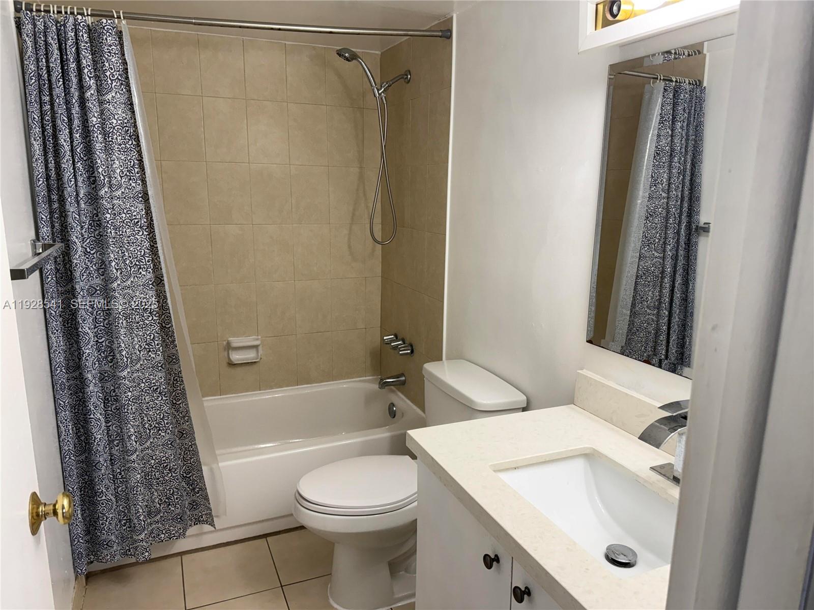 9001 Southwest 77th Avenue, Unit C709 Miami, FL 33156 - Photo 10 of 17 a bathroom with a sink toilet and shower