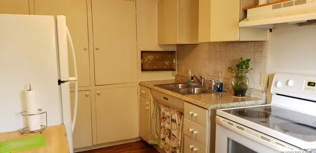 a kitchen with a sink and a refrigerator