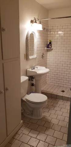 a view of a hallway with wooden floor and furniture