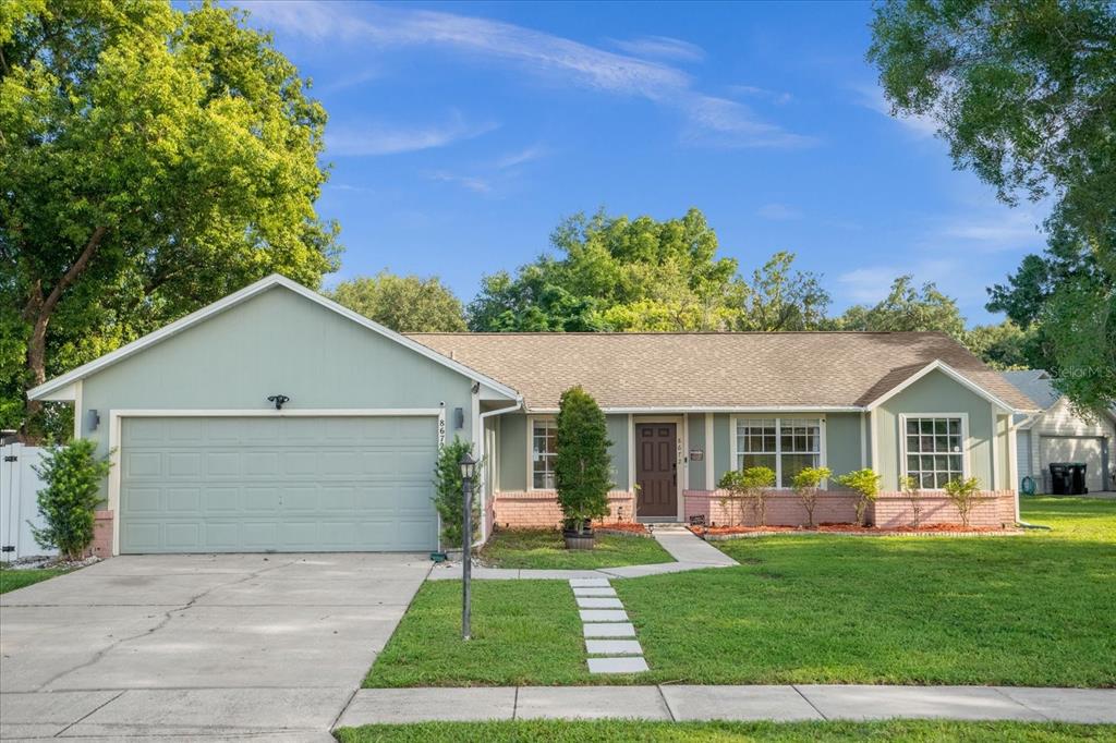 a front view of house with yard and green space