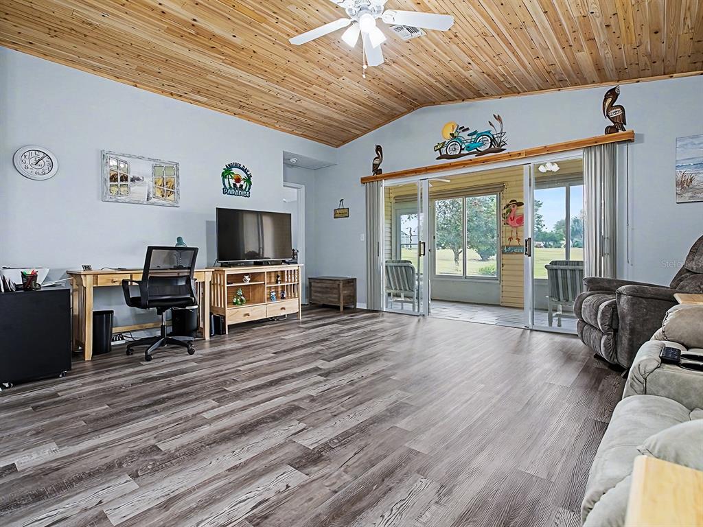 634 Timbercrest Drive Leesburg, FL 34748 - Photo 12 of 38 a living room with furniture wooden floor and flat screen tv