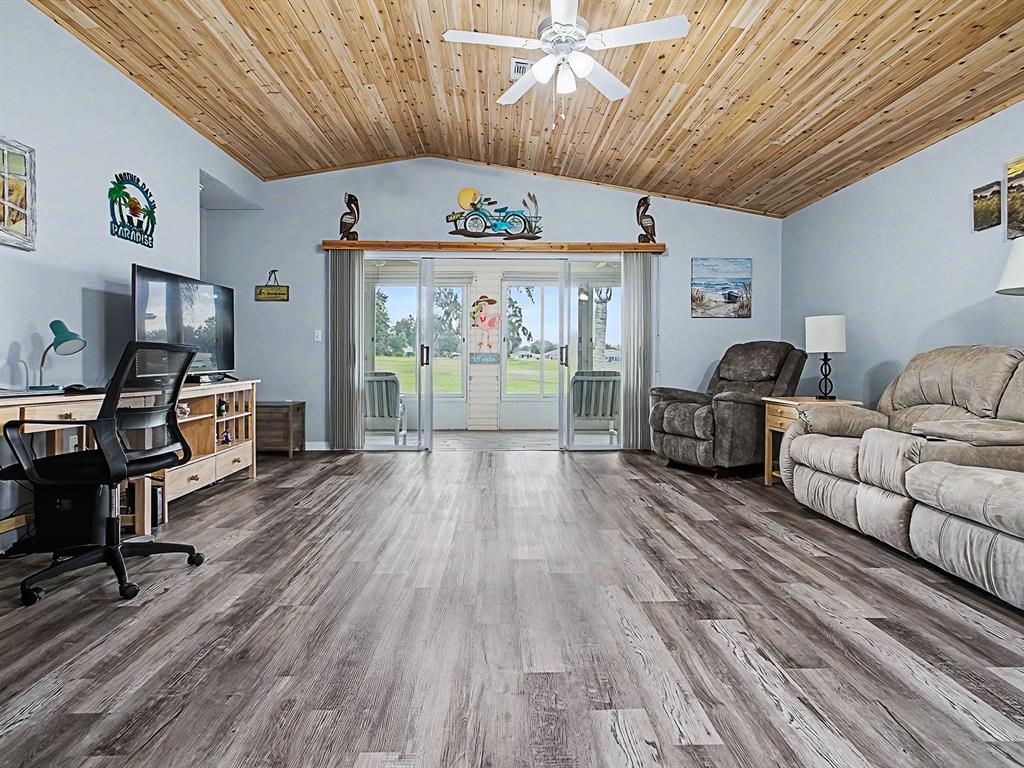 634 Timbercrest Drive Leesburg, FL 34748 - Photo 13 of 38 a view of a livingroom with furniture a flat screen tv