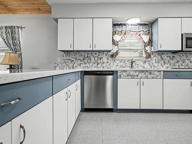 a kitchen with stainless steel appliances granite countertop a sink and cabinets