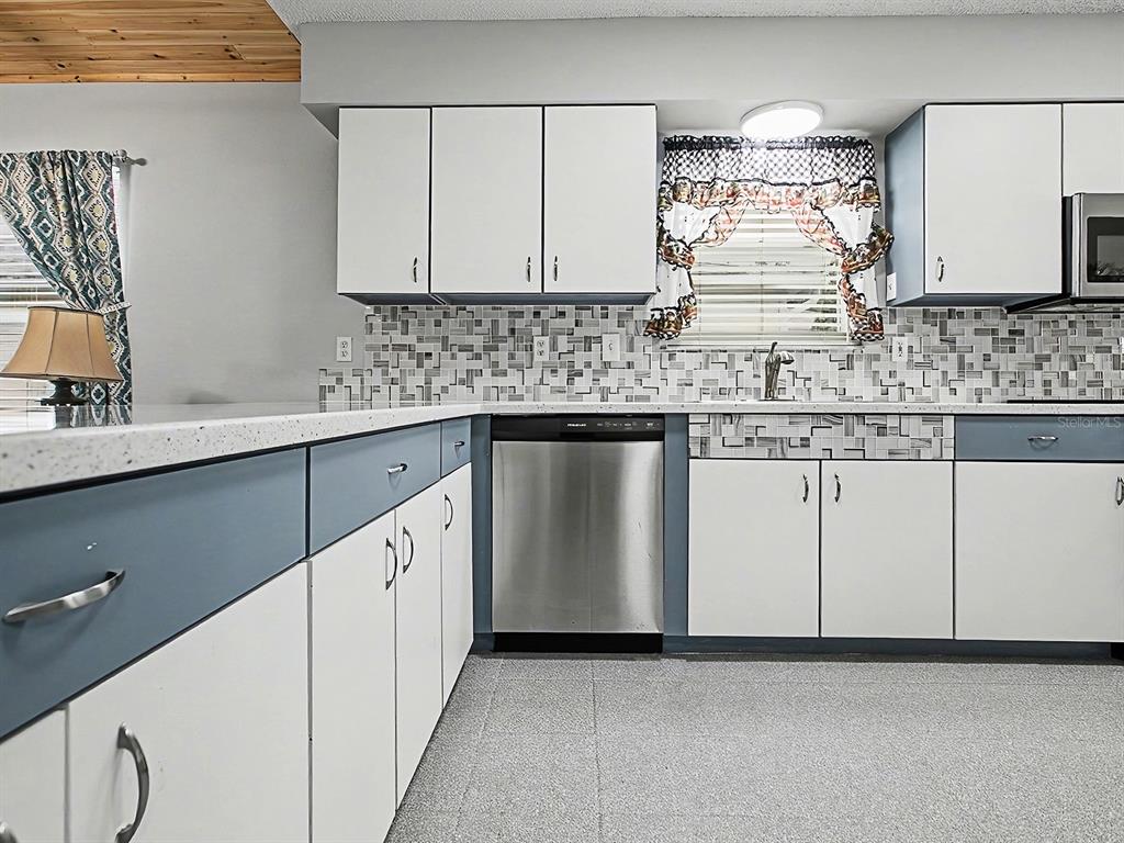 634 Timbercrest Drive Leesburg, FL 34748 - Photo 14 of 38 a kitchen with stainless steel appliances granite countertop a sink and cabinets