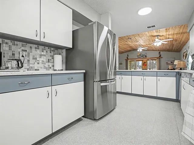 a kitchen with stainless steel appliances granite countertop a refrigerator and a stove