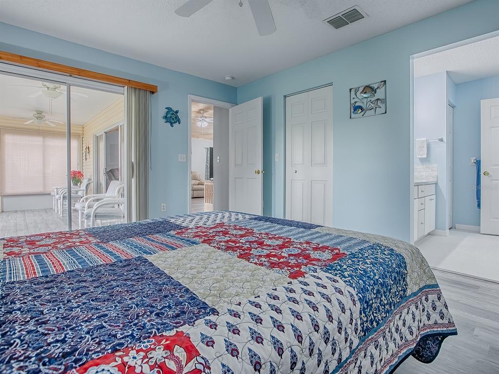 634 Timbercrest Drive Leesburg, FL 34748 - Photo 22 of 38 a bedroom with a bed and a mirror