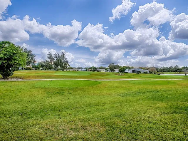 a view of a golf course with an trees