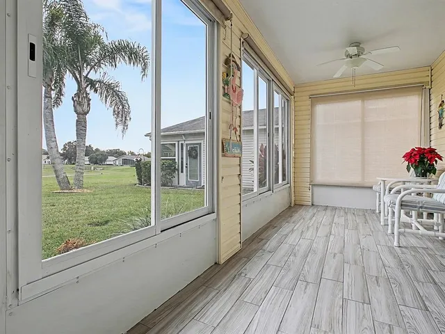 a view of a house with a porch and furniture