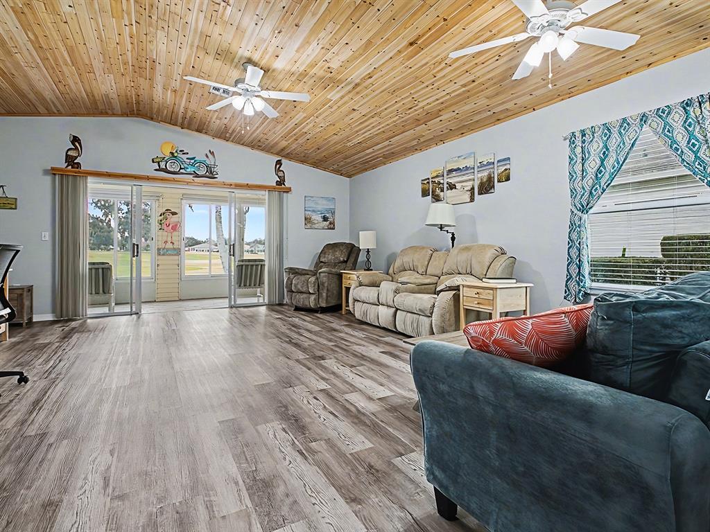 634 Timbercrest Drive Leesburg, FL 34748 - Photo 8 of 38 a living room with furniture and a large window
