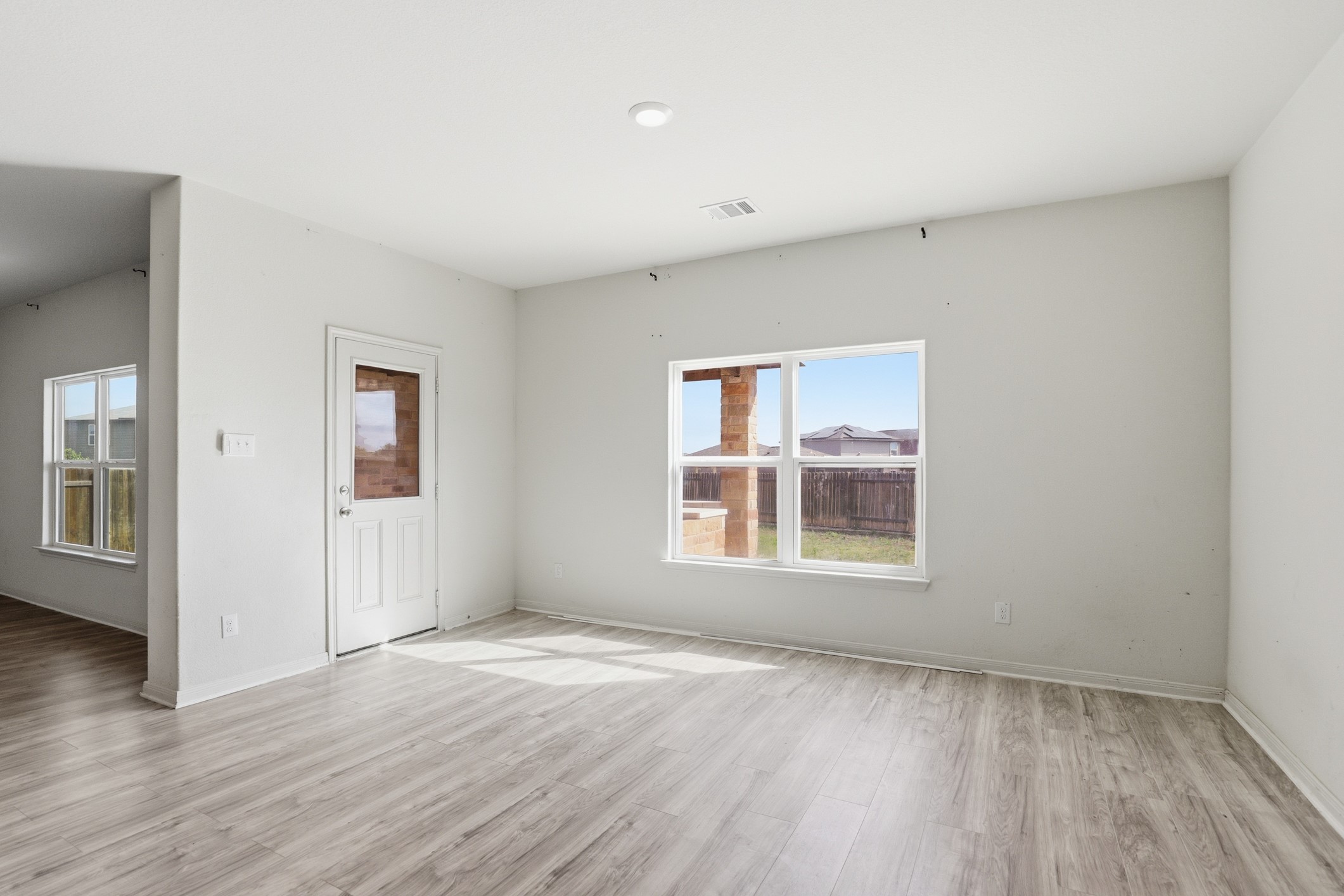 300 Hyacinth Way Jarrell, TX 76537 - Photo 13 of 30 an empty room with wooden floor and windows