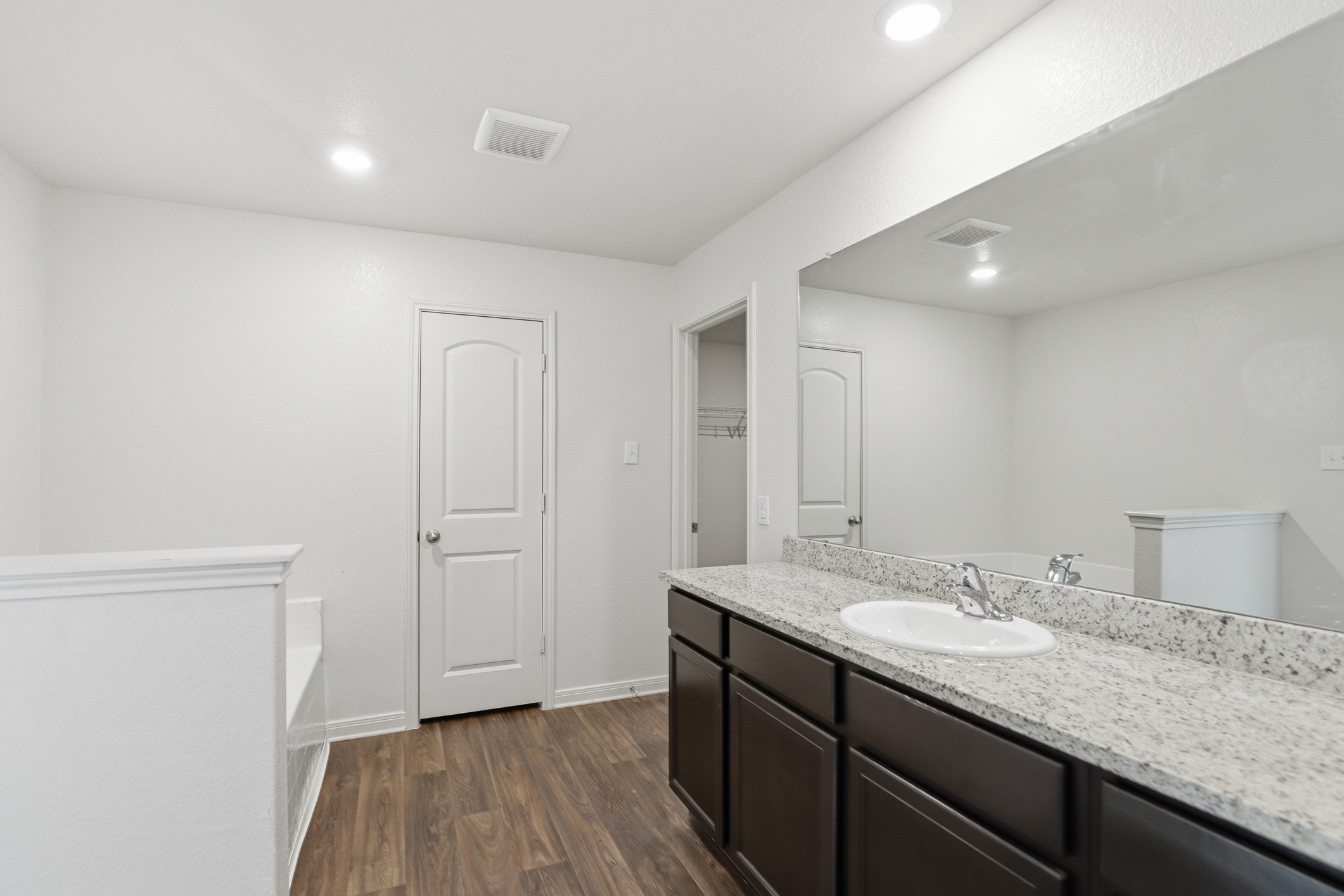 300 Hyacinth Way Jarrell, TX 76537 - Photo 20 of 30 a bathroom with a granite countertop sink and a mirror