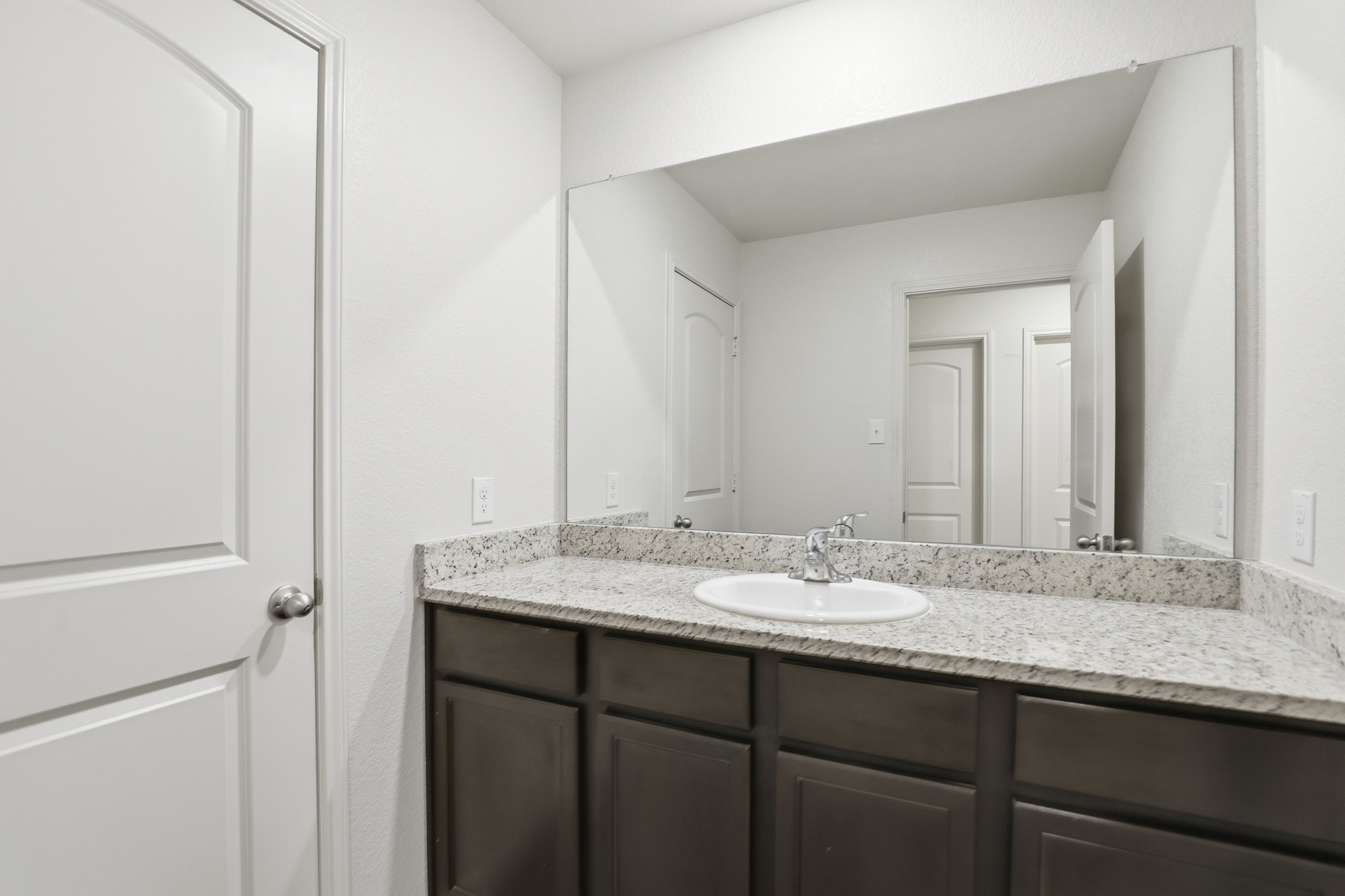 300 Hyacinth Way Jarrell, TX 76537 - Photo 23 of 30 a bathroom with a granite countertop sink and a mirror