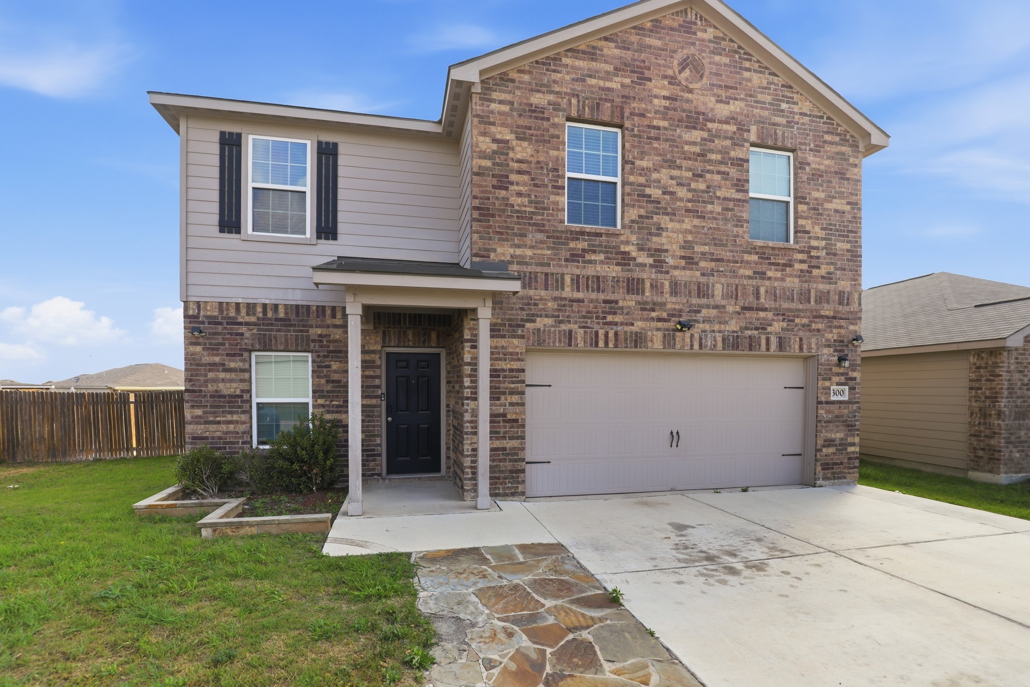 300 Hyacinth Way Jarrell, TX 76537 - Photo 3 of 30 a view of a house with a yard and a garage