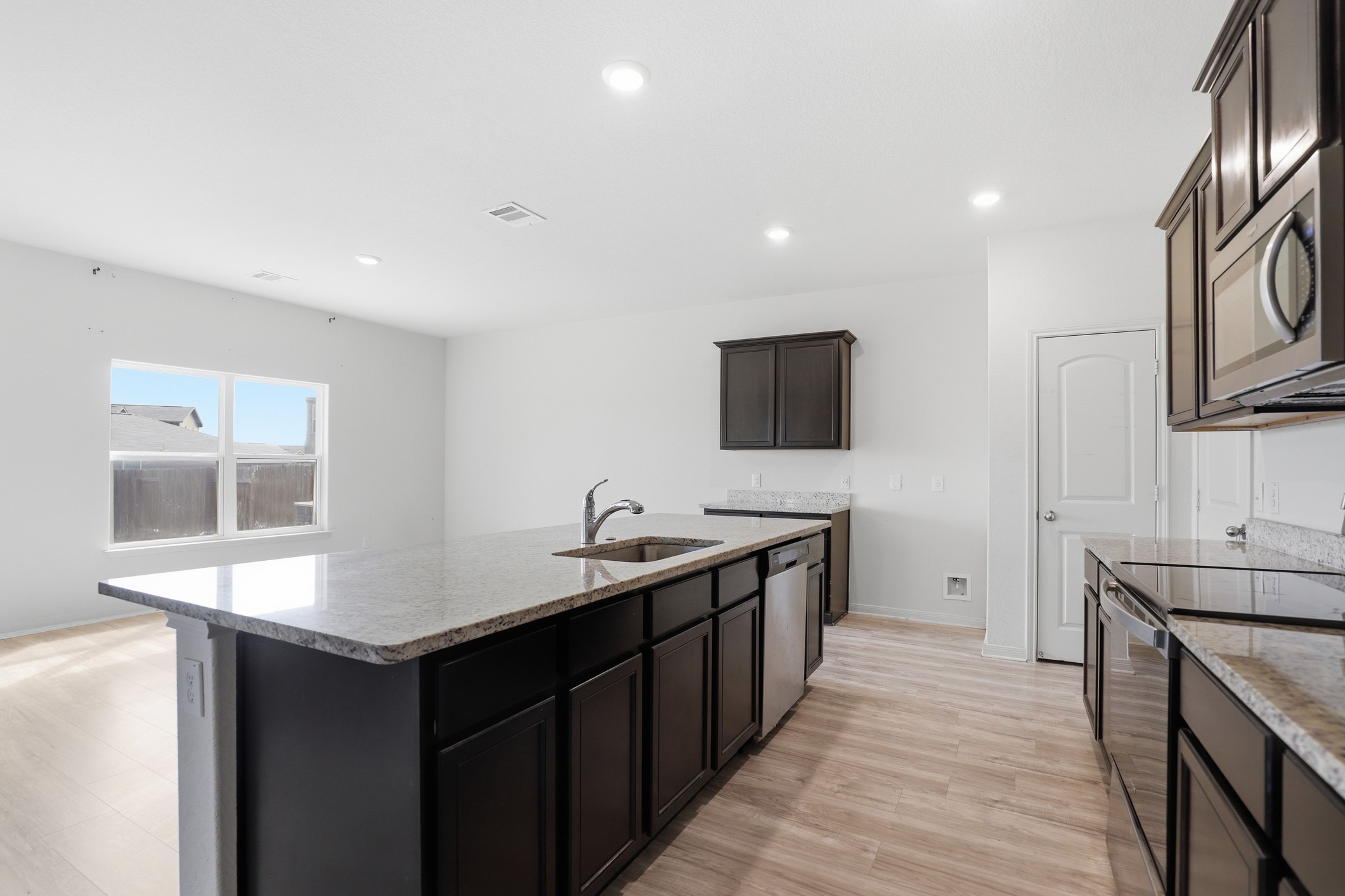 300 Hyacinth Way Jarrell, TX 76537 - Photo 9 of 30 a kitchen with stainless steel appliances granite countertop a sink stove and refrigerator