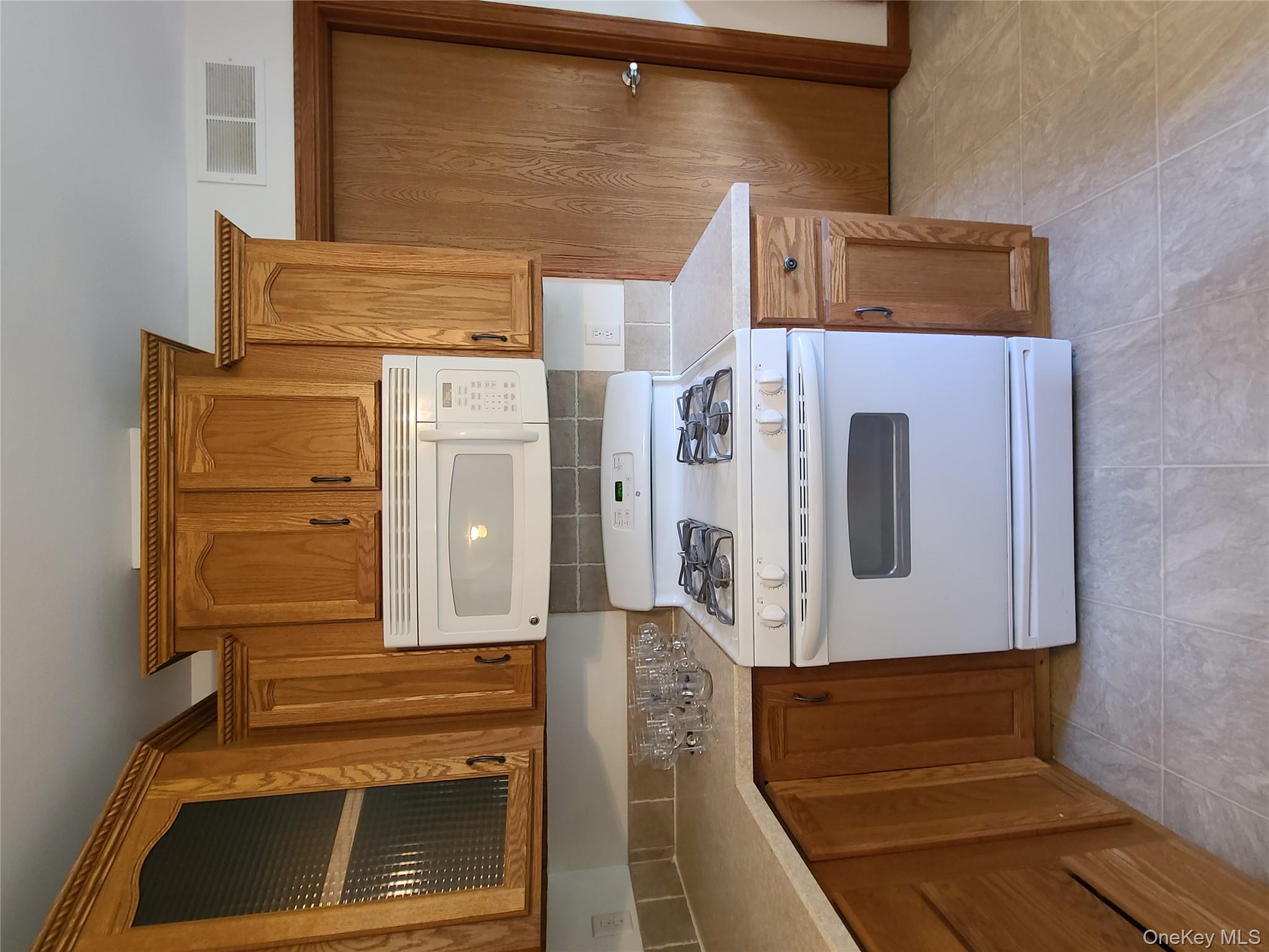 82 Benton Hollow Road Liberty, NY 12754 - Photo 9 of 36 a stove top oven sitting inside of a kitchen