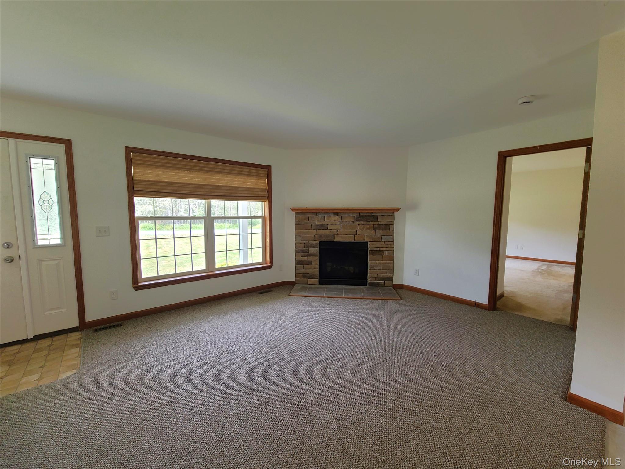 82 Benton Hollow Road Liberty, NY 12754 - Photo 12 of 36 an empty room with furniture and a fireplace