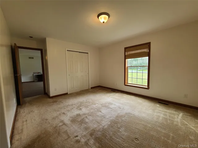 an empty room with furniture and a fireplace