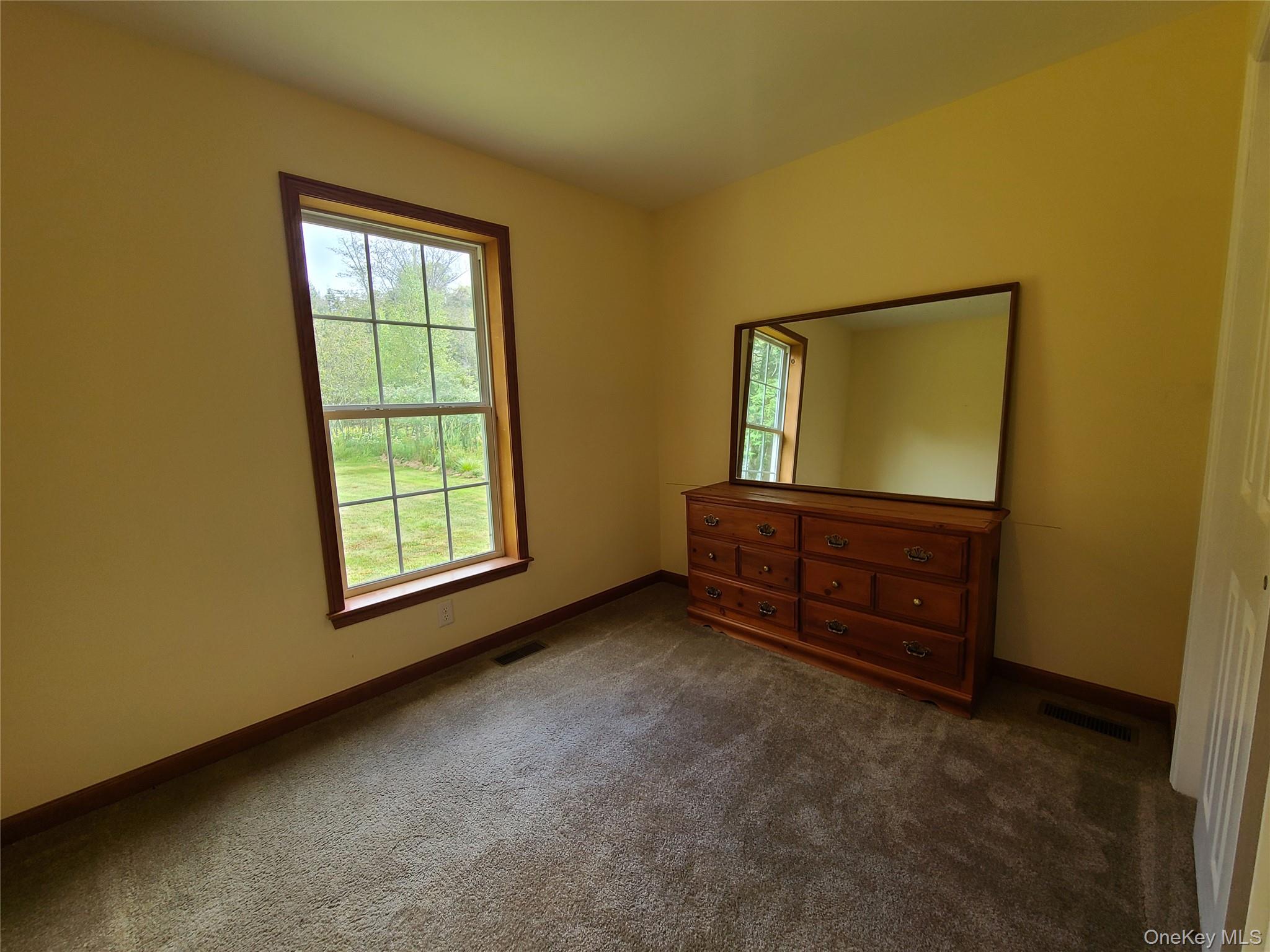 82 Benton Hollow Road Liberty, NY 12754 - Photo 18 of 36 an empty room with windows and cabinet