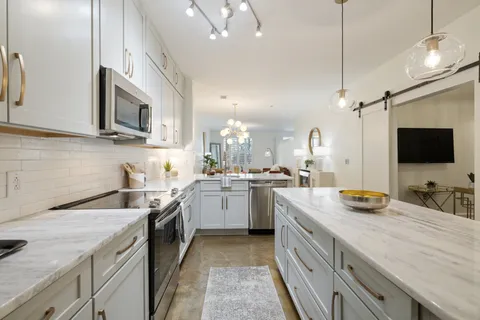 a kitchen with a sink stove and microwave
