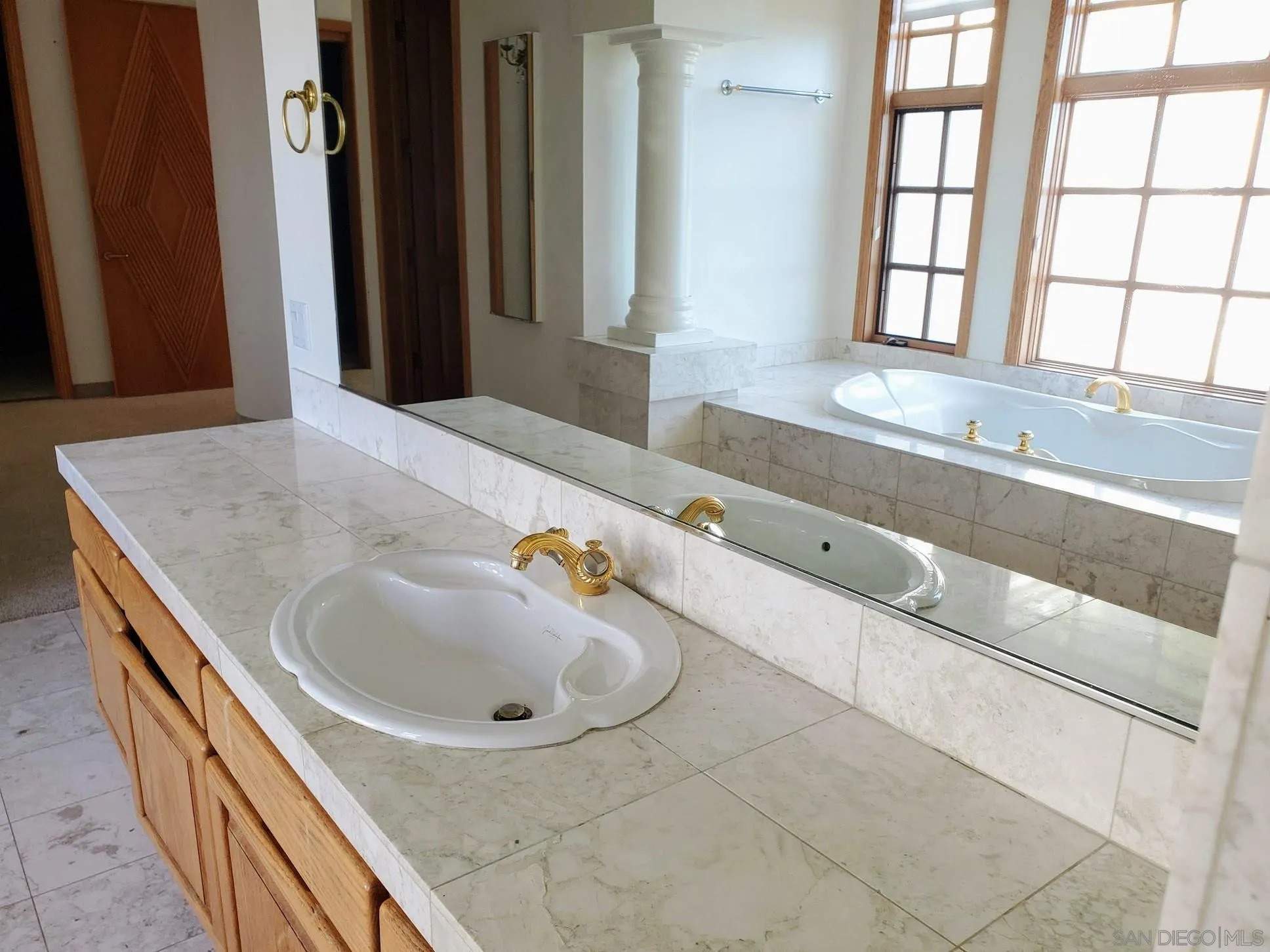 14316 Twisted Branch Road Poway, CA 92064 - Photo 15 of 36 a bathroom with a granite countertop sink and a window