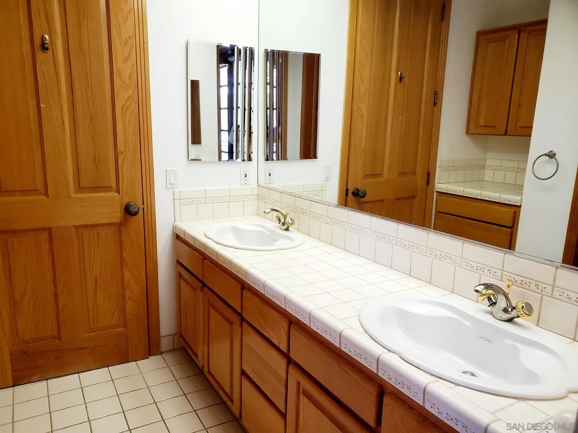 14316 Twisted Branch Road Poway, CA 92064 - Photo 20 of 36 a bathroom with a double vanity sink and a mirror