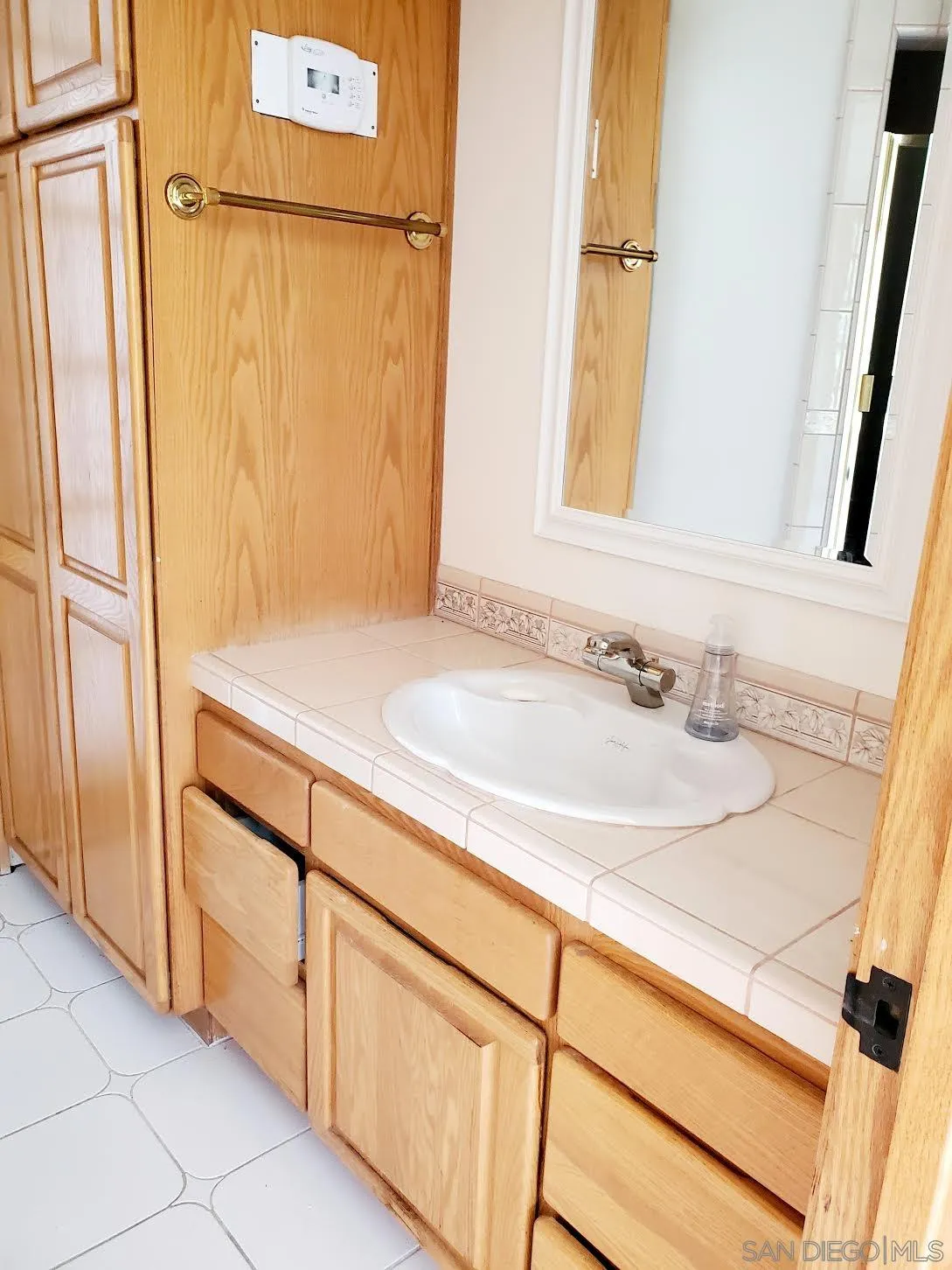 14316 Twisted Branch Road Poway, CA 92064 - Photo 24 of 36 a bathroom with a sink and a mirror