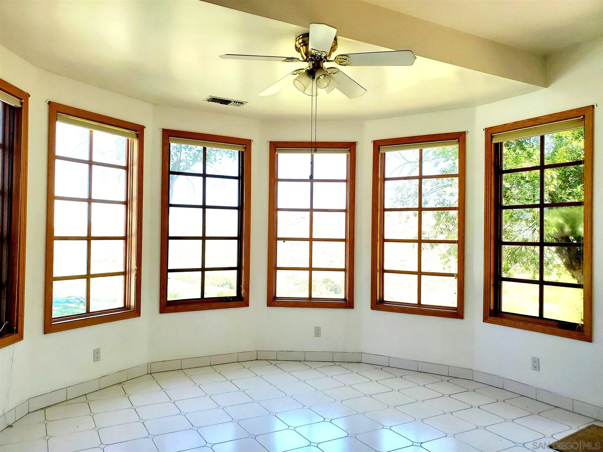 14316 Twisted Branch Road Poway, CA 92064 - Photo 28 of 36 an empty room with chandelier fan and windows