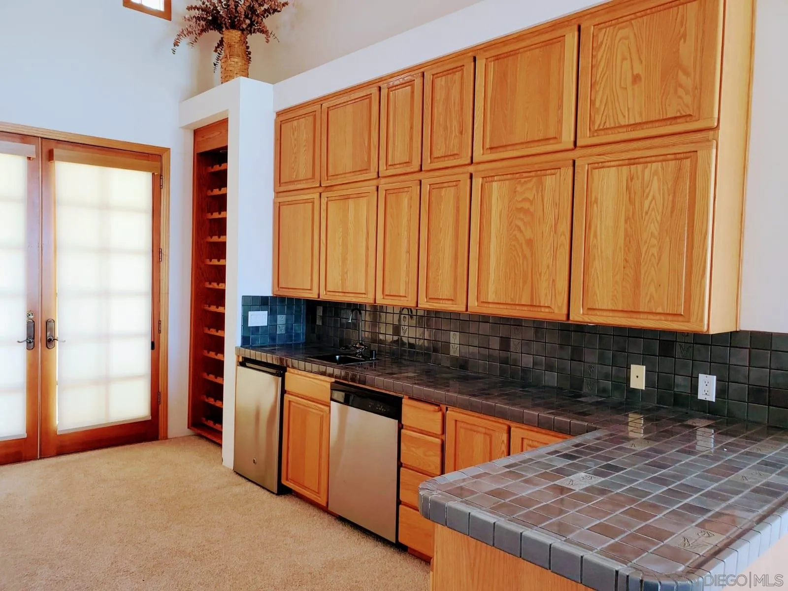 14316 Twisted Branch Road Poway, CA 92064 - Photo 7 of 36 a kitchen with stainless steel appliances granite countertop a sink a stove cabinets and a dining table