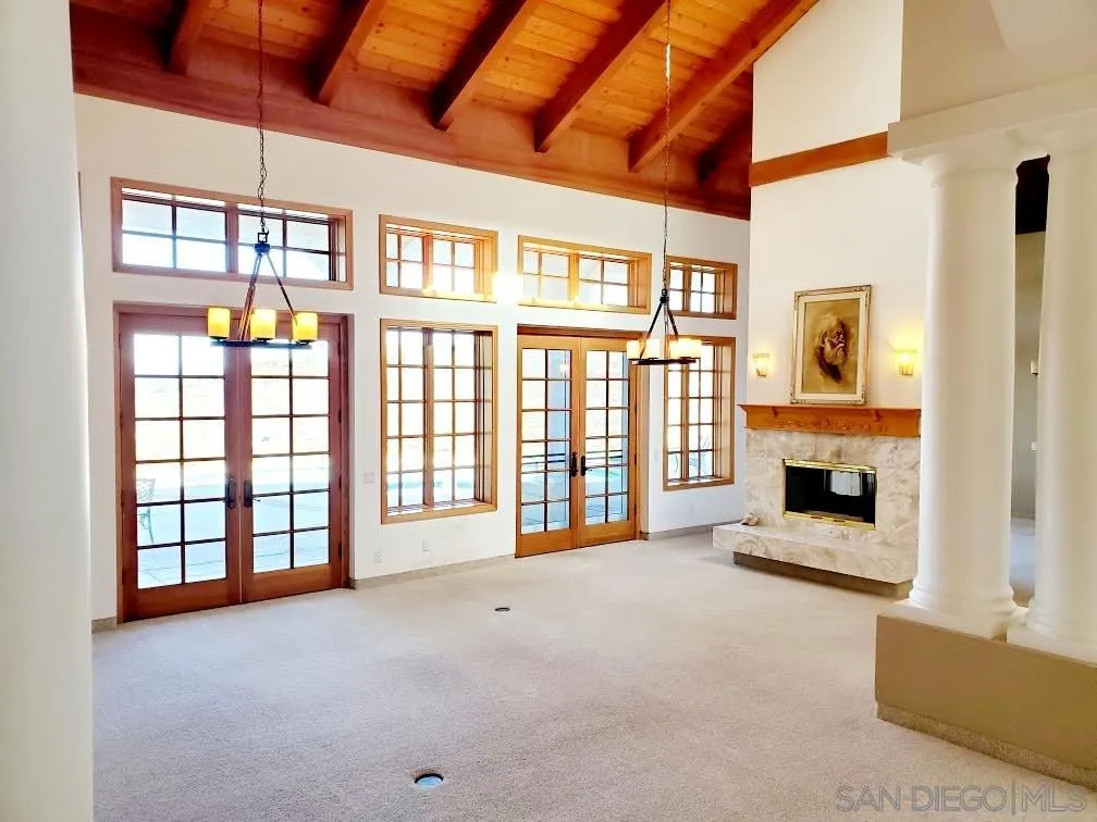 14316 Twisted Branch Road Poway, CA 92064 - Photo 9 of 36 a view of an empty room with a fireplace and a window
