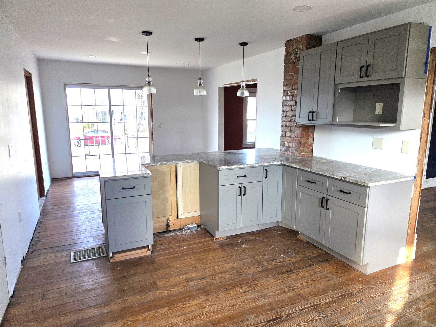 290 West Kankakee Avenue Herscher, IL 60941 - Photo 6 of 13 a kitchen with stainless steel appliances granite countertop a sink a stove a refrigerator and island with wooden floor