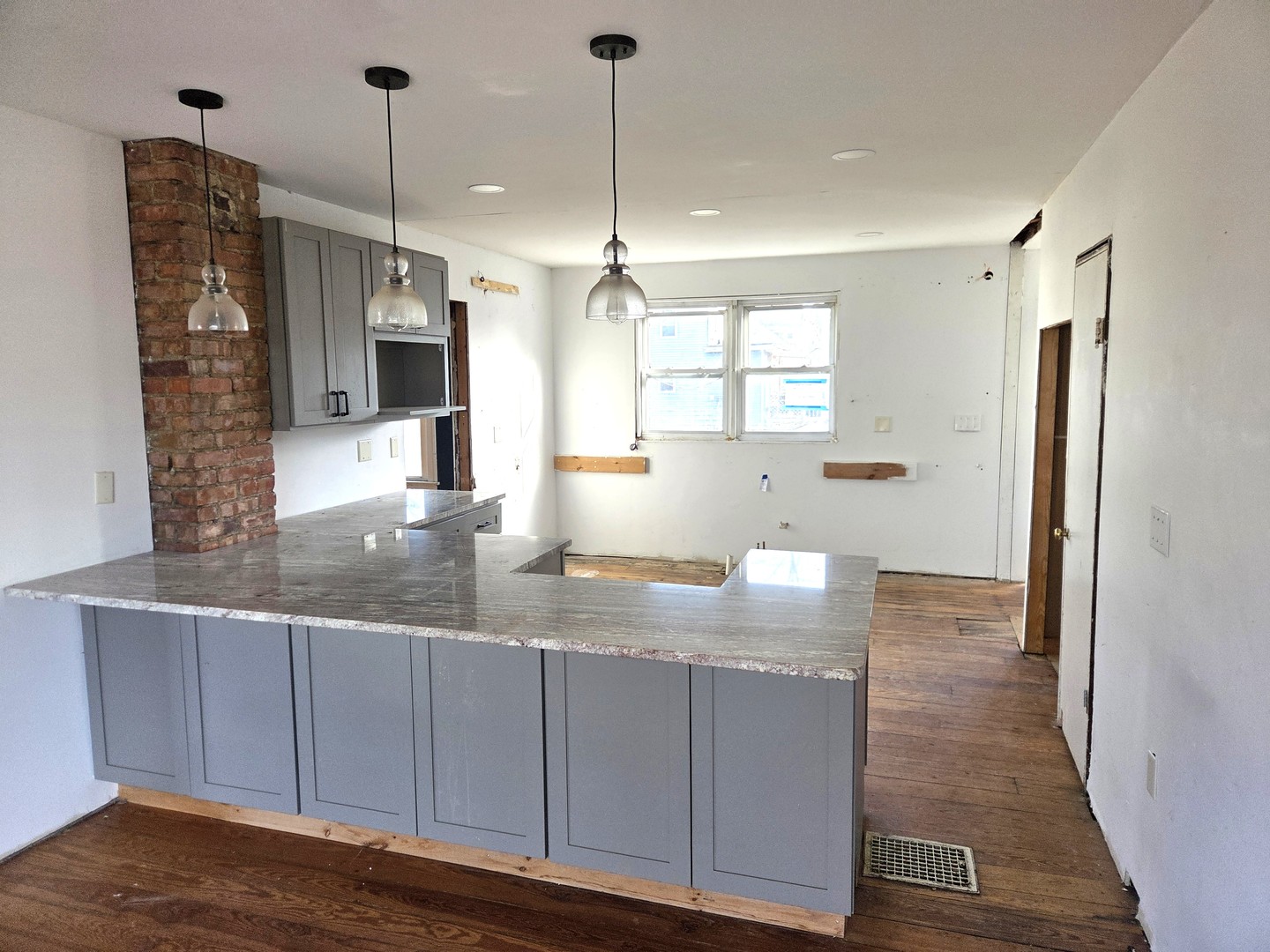 290 West Kankakee Avenue Herscher, IL 60941 - Photo 7 of 13 a view of a kitchen counter space and wooden floor