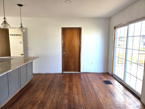 a view of a kitchen with wooden floor and a sink