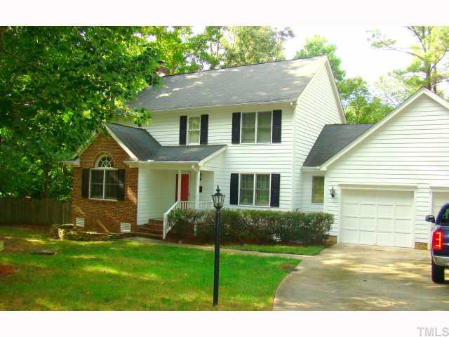 3409 Greenville Loop Road Wake Forest, NC 27587 - Photo 1 of 12 a front view of a house with a yard and potted plants