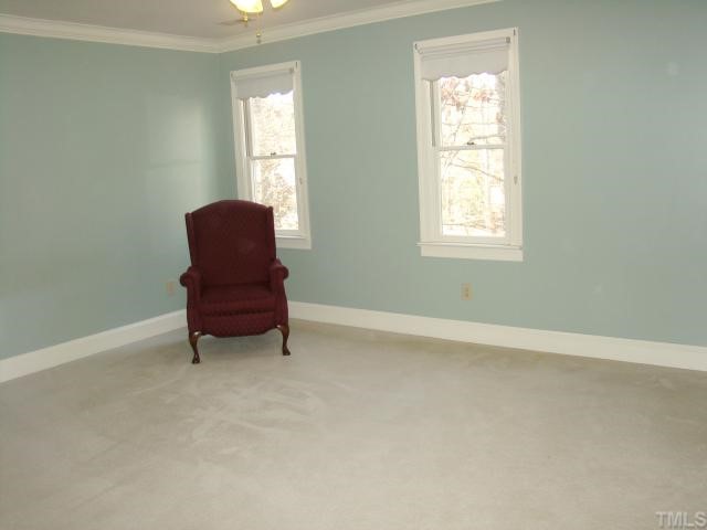 3409 Greenville Loop Road Wake Forest, NC 27587 - Photo 7 of 12 an empty room with chair and windows