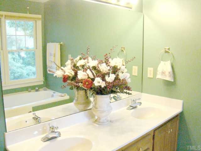 3409 Greenville Loop Road Wake Forest, NC 27587 - Photo 8 of 12 a bathroom with a sink and a mirror