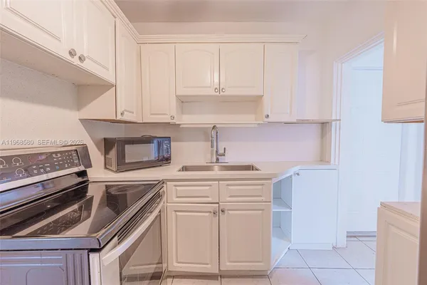 a kitchen with cabinets appliances and a counter space