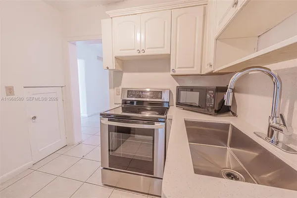 a kitchen with granite countertop a sink and a stove