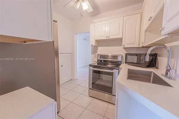 a kitchen with cabinets and stainless steel appliances