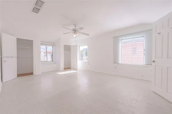 an empty room with windows and entrance