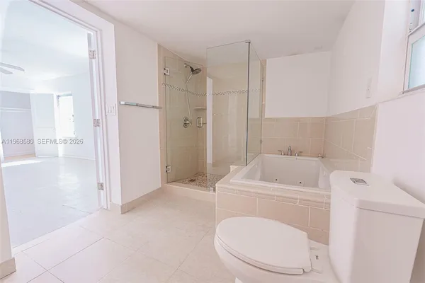 a bathroom with a toilet and a shower