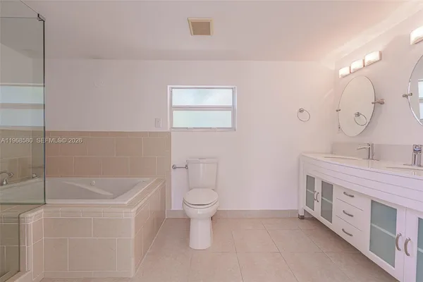 a bathroom with a double vanity sink mirror and toilet