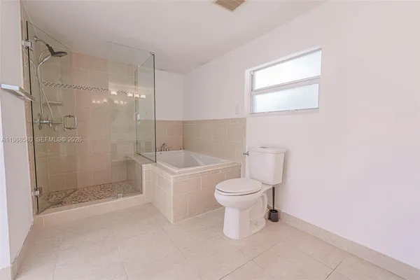 a bathroom with a toilet sink and shower
