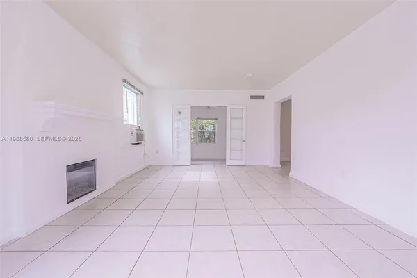 a view of an empty room with a window