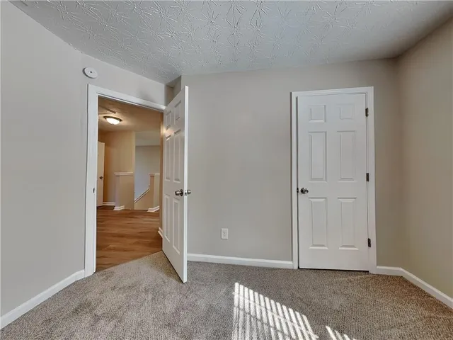 a view of a room with an empty space and wooden floor