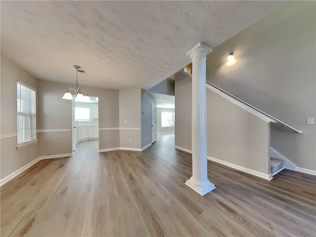 a view of a room with wooden floors and staircase