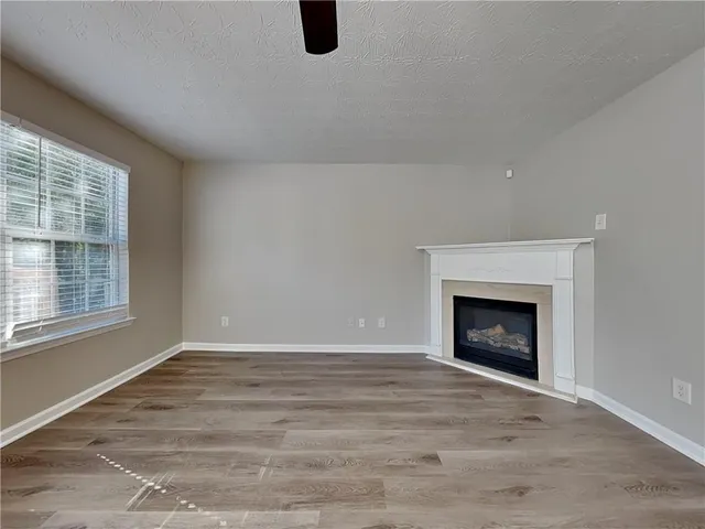 a view of empty room with a fireplace