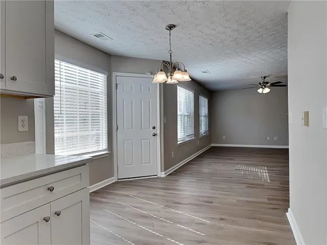 a view of a room with window wooden floor and chandelier