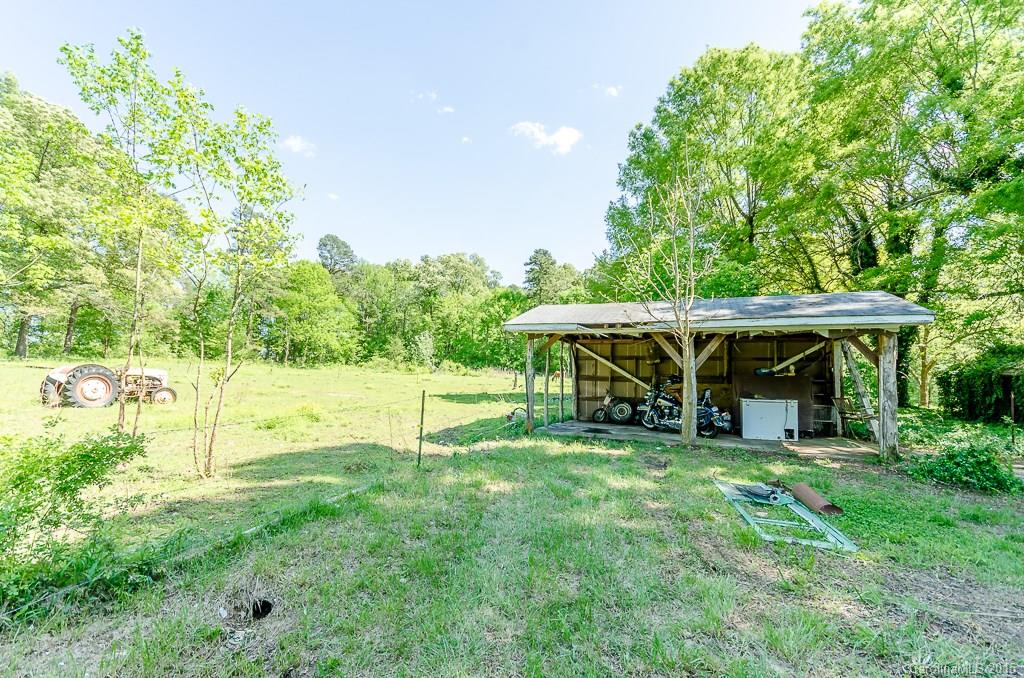4401 Austin Road Monroe, NC 28112 - Photo 15 of 22 a view of a house with backyard sitting area and garden