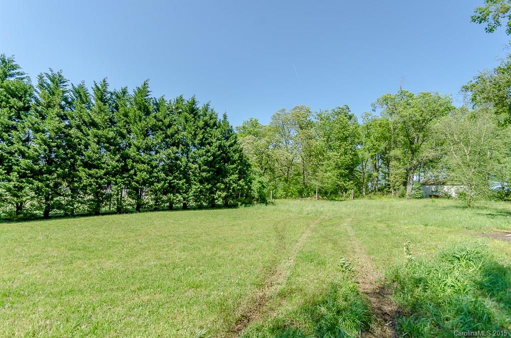 4401 Austin Road Monroe, NC 28112 - Photo 18 of 22 a view of a grassy field with trees in the background